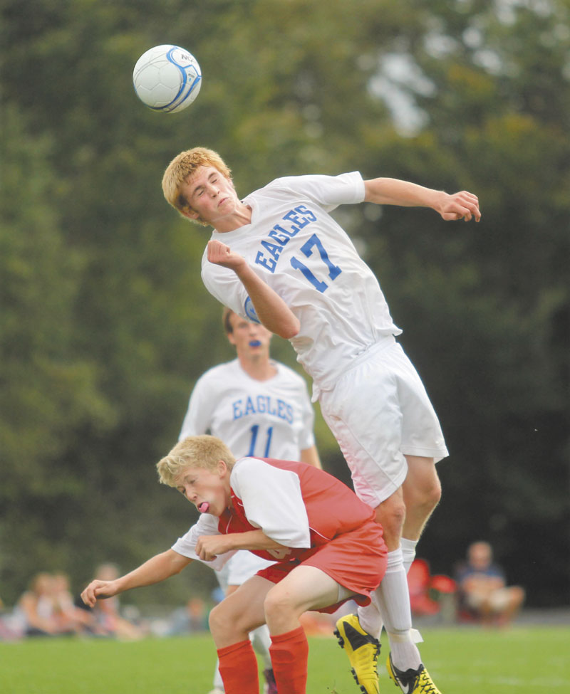 LOOK OUT BELOW: Erskine Academy’s Tyler Adams lands on Cony High School’s Connor Perry after going up for a header during the second half of Saturday’s game in South China.