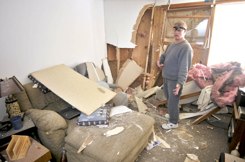 Jim Pinkham stands in his apartment this morning telling the story of how a vehicle crashed through the wall on Friday evening at 36 Water Street in Augusta.