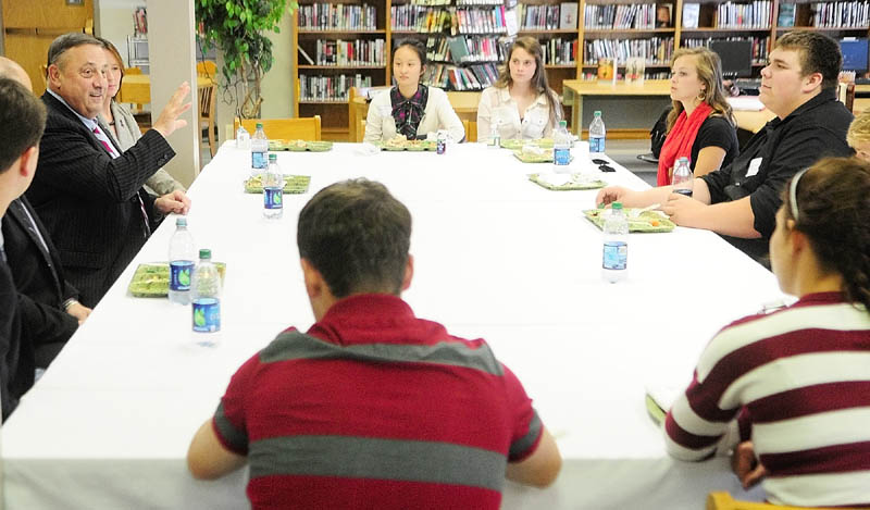 Staff photo by Joe Phelan Gov. Paul LePage, left, chats with leaders of the the Friends of Rachel group over lunch in the library on Wednesday afternoon at Erskine Academy in China. After lunch, LePage spoke about domestic abuse and violence at an all school assembly in the gym.