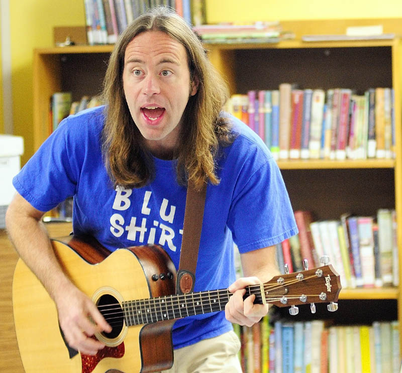 Staff photo by Joe Phelan Harley Smith, whose stage name is Mr. Harley, performs Wednesday morning in the children's room of the The Charles M. Bailey Public Library in Winthrop.