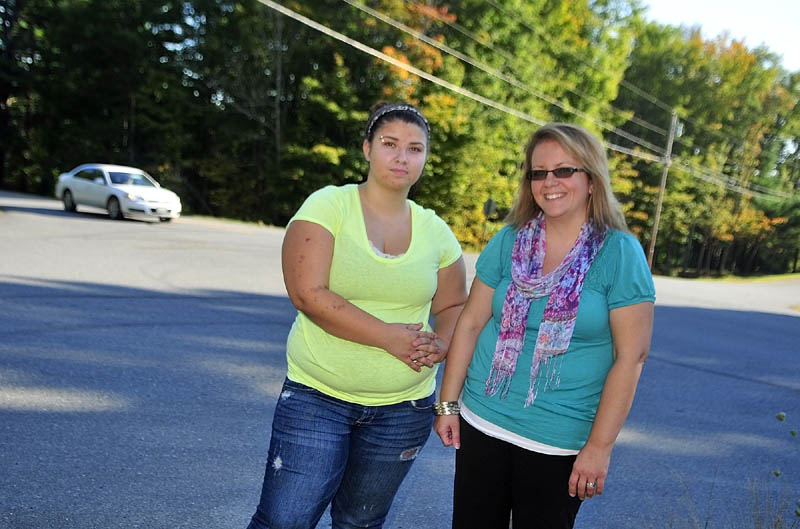 Emily Cote, left, and her mother Malinda Caron stand at the intersection of the North Hunts Meadow and Cooper Roads on Friday afternoon. It used to be the bus stop where last year Cote caught the bus from Whitefield to Cony High School.