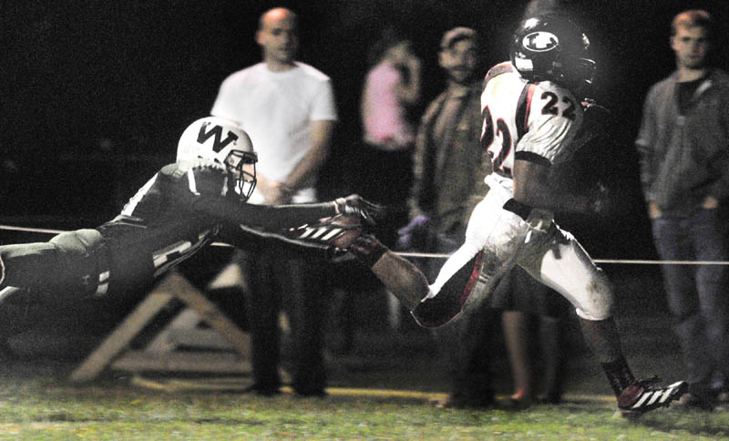 Staff photo by Joe Phelan Lisbon running back Quincy Thompson, left, out runs Winthrop corner back Damion Hanson into the corner of the end zone to score during a game on Friday night at Maxwell Field in Winthrop.