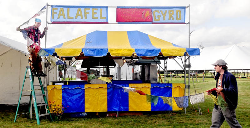 READY-SET-GYRO: Don Gardner, left, and his brother Cam set up their food concession booth at the Maine Organic Farmers and Gardeners Association site of the 36th annual Common Ground Fair in Unity on Tuesday. The fair runs from Friday through Sunday featuring workshops, lectures, vendors, crafts, farm animals, food and entertainment.