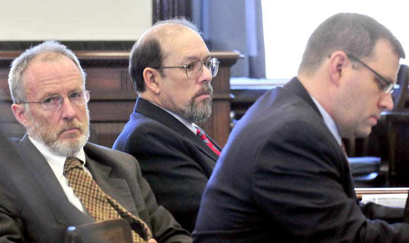 Staff photo by David Leaming COLD CASE: Flanked by his attorneys John Alsop, left, and John Martin, defendant Jay Mercier listens to opening statements in the trial in the death of Rita St. Peters in Somerset Superior Court in Skowhegan on Thursday.