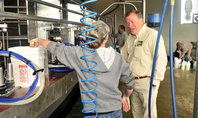 Second District Congressional candidate Kevin Raye speaks with Flood Brothers worker Kate Poulin and other employees during a campaign stop at the Clinton farm on Thursday.