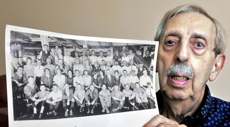 Peter Joseph holds a photograph taken in the early 1930s of Wyandotte Mill employees, including his father, John Joseph Sr.