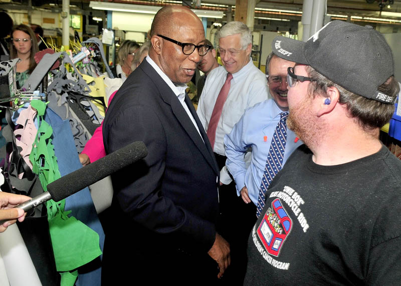 TRADE: U.S. Trade Representative Ambassador Ron Kirk speaks with New Balance employee Jeff Clair during a tour in Norridgewock on Thursday. U.S. Rep. Mike Michaud, center, also toured the company.