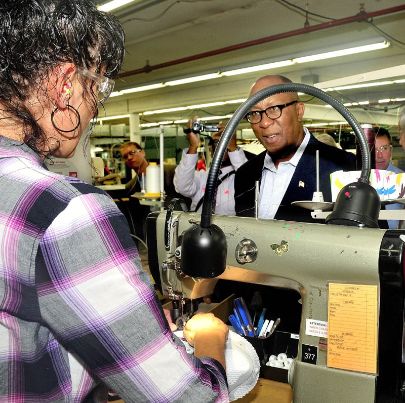 LEARNING THE TRADE: U.S. Trade Representative Ambassador Ron Kirk listens to New Balance company employee Anissa Clark explain her work during a tour of the Norridgewock plant on Thursday.