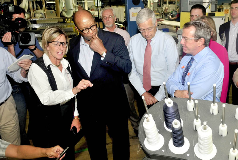 TOUR OF DUTY: New Balance Plant Manager Raye Wentworth explains a shoe- making process to U.S. Trade Representative Ambassador Ron Kirk and U.S. Rep. Mike Michaud at the Norridgewock plant on Thursday. Company President Rob DeMartini is at right.