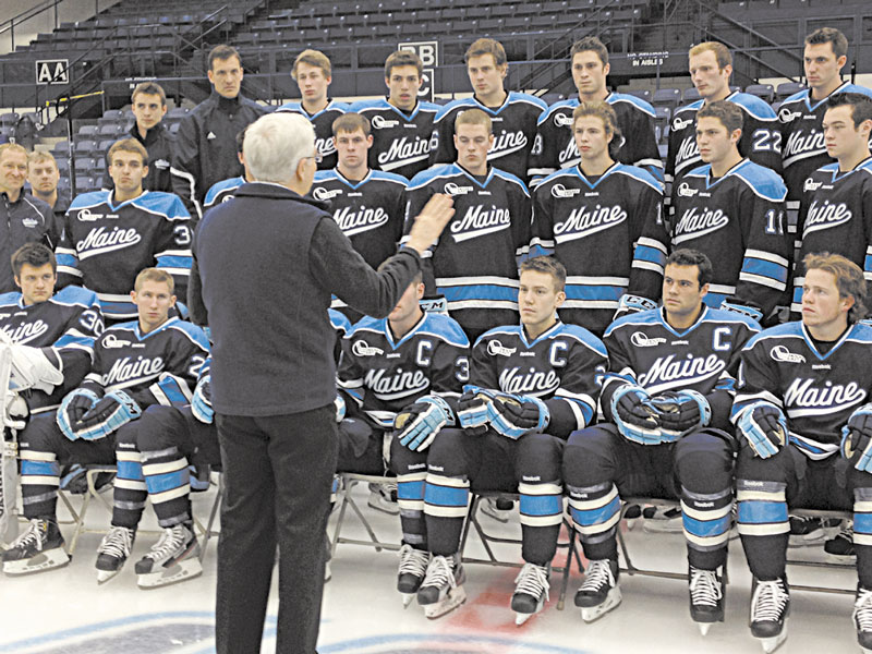 SMILE: University of Maine president Paul Ferguson talks to members of the hockey team during photo day on Wednesday in Orono.
