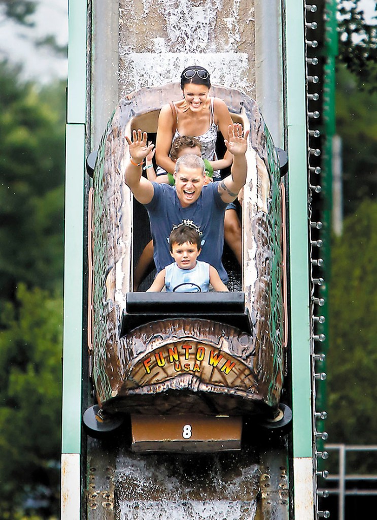 Brian Arel of South Portland rides the Thunder Falls Log Fume with his wife Jill and their children Aiden, 6, front, and Keegan, 2, at Funtown Splashtown USA in Saco on Friday.
