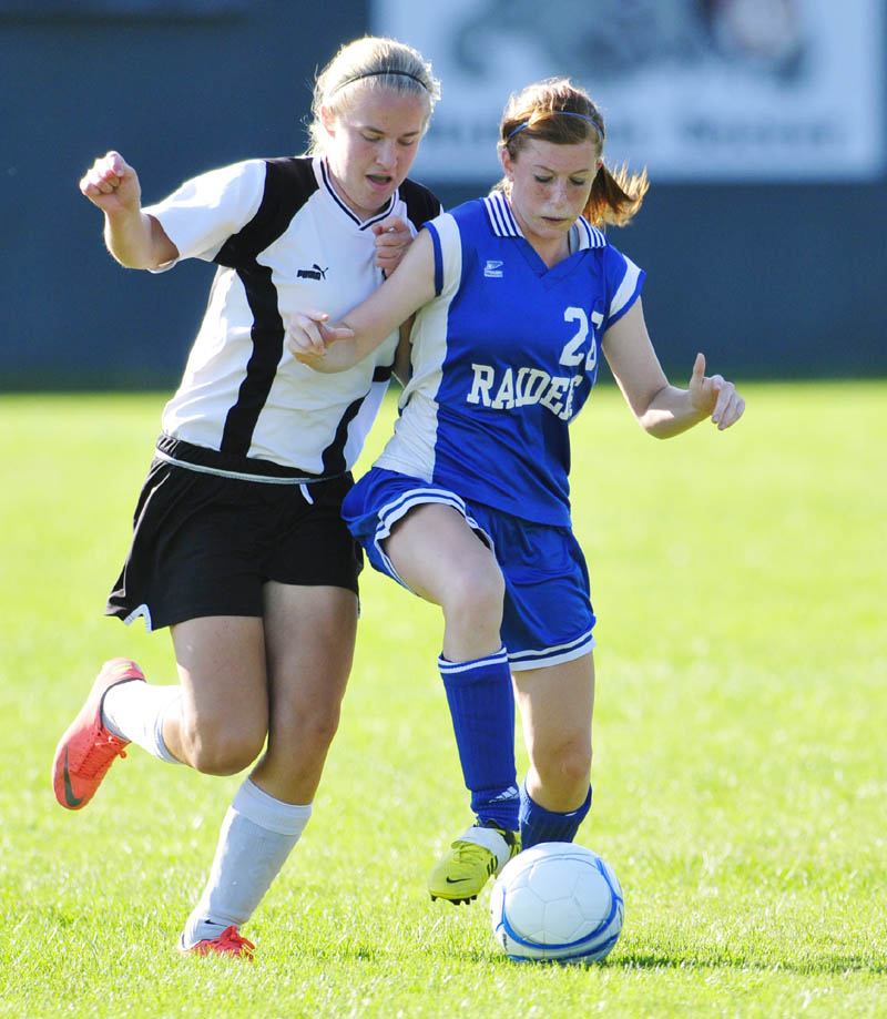 Hall-Dale's Morgan Rush, left, gets stopped by Oak Hill defender Athena Ritcheson during a game on Wednesday afternoon at Hall-Dale High School in Farmingdale.