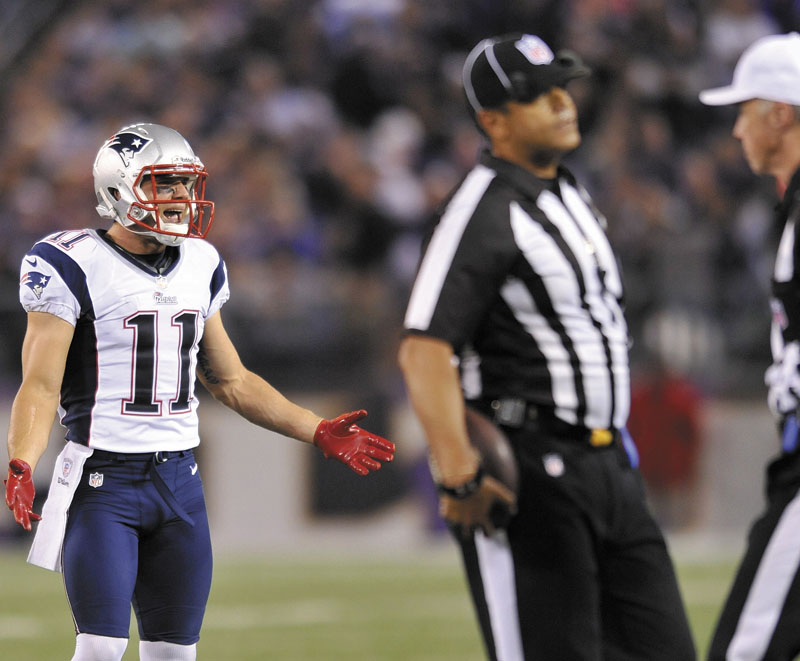 NOT PLEASED: New England Patriots wide receiver Julian Edelman (11) protests a penalty as officials confer in the first half of the Patriots’ 31-30 loss to the Baltimore Ravens on Sunday in Baltimore.