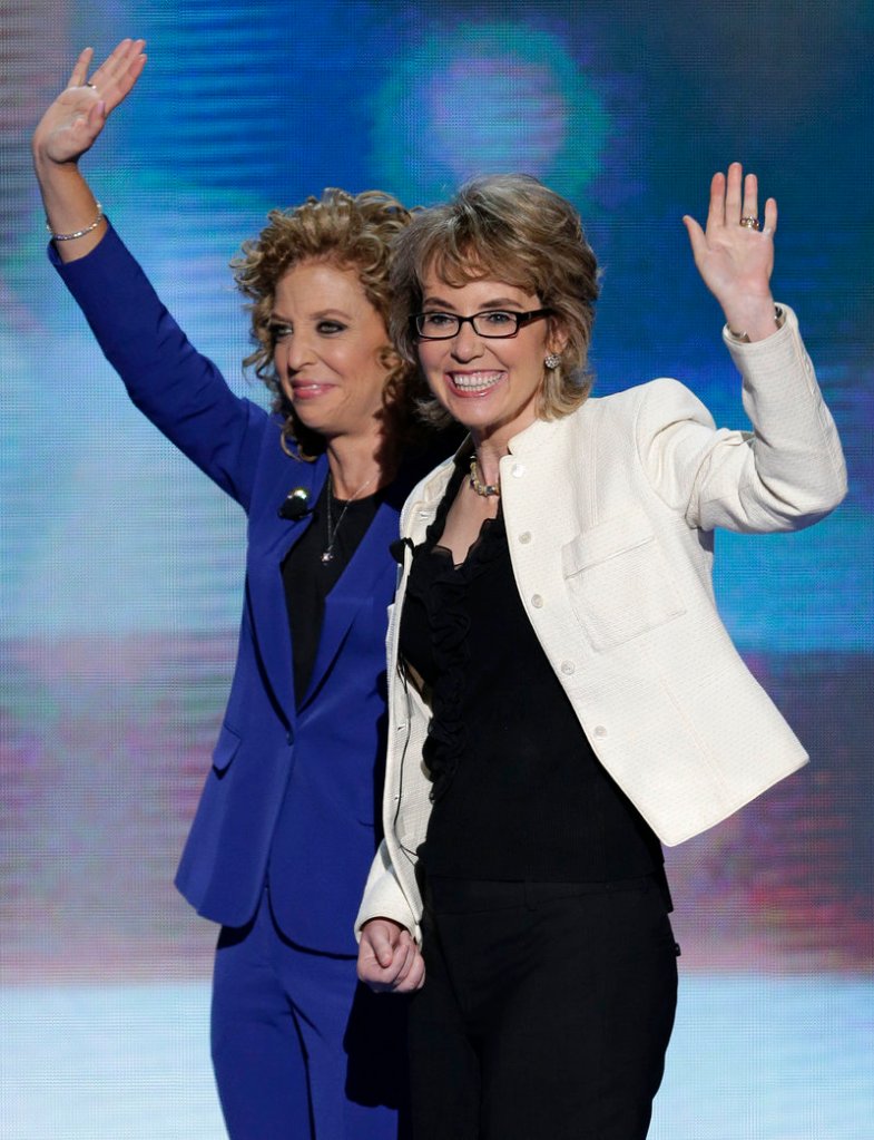 Former Rep. Gabrielle Giffords waves after reciting the Pledge of Allegiance with Democratic National Committee Chairwoman Rep. Debbie Wasserman Schultz in Charlotte, N.C., Thursday.