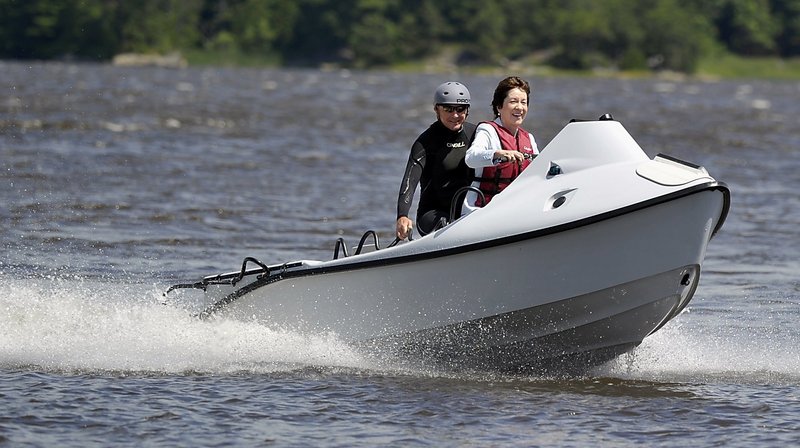 Sen. Susan Collins pilots a rescue craft in July built at the Hodgdon Defense Composites Facility in Bath for the U.S. Air Forces Special Command. She is accompanied Peter Maguire, co-founder of Rapid Response Technology, designer of the craft. Collins has expressed concerns about possible “meat-ax cuts” to defense programs.