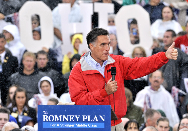 Republican presidential candidate Mitt Romney campaigns in the rain Friday in Painesville, Ohio. “There will not be a second term,” he told the crowd.