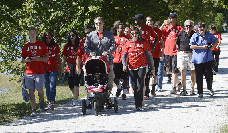A group known as Gabby’s Gang walks for Gabby Maines, 8, of Waterville, who has type 1 diabetes, during the Juvenile Diabetes Research Foundation International’s walk to cure diabetes at Payson Park in Portland on Sunday. Chad and Alex Higgins of South Portland lead the way while pushing 8-month-old Molly in a stroller.