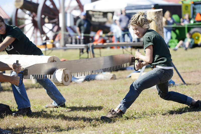 Jenny Helm of Waitsfield, Vt., works at crosscut sawing with other members of the Colby College Woodsmen’s Team on Sunday at the Cumberland County Fair. Helm graduated from Colby in 2011.