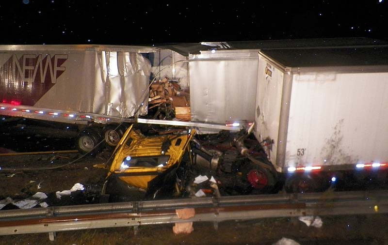 Two tractor-trailer trucks lie in the median of Interstate 95 in Biddeford on Friday night after they collided.