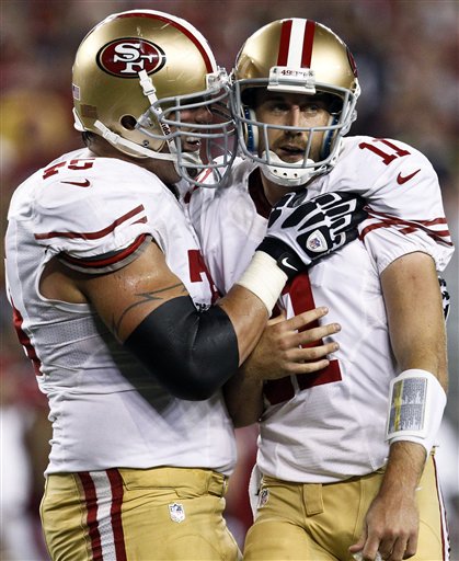 San Francisco 49ers' Alex Smith (11) celebrates his second touchdown pass of the game against the Arizona Cardinals with Alex Boone, left, during the first half of an NFL football game, Monday, Oct. 29, 2012, in Glendale, Ariz. (AP Photo/Ross D. Franklin) NFLACTION12; University of Phoenix Stadium