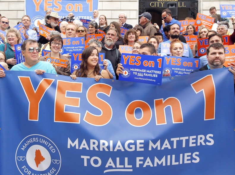 Supporters hold a banner on the steps of Portland City Hall during a rally in September supporting the same-sex marriage referendum in Maine.
