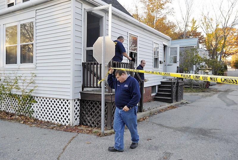 Sgt. Joel Davis and other investigators from the State Fire Marshal's Office leave the home of Patricia Noel, 62, of 44 Wesley Ave., on Tuesday, October 23, 2012.