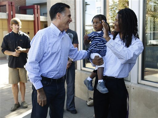Republican presidential candidate, former Massachusetts Gov. Mitt Romney greets passers-by as he makes an unscheduled stop at a Chipotle restaurant in Denver, Tuesday, Oct. 2, 2012. (AP Photo/Charles Dharapak)