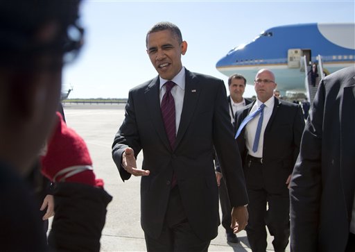 President Barack Obama greets people as he arrives at John F. Kennedy International Airport, Tuesday, Oct. 16, 2012, in New York, en rout to Hempstead, N.Y. and a presidential debate. (AP Photo/Carolyn Kaster)