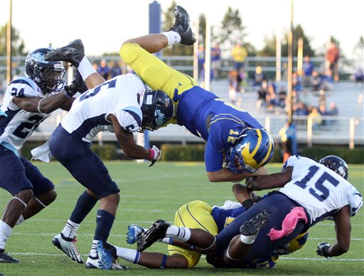 Maine defensive backs, from left, Khari Al-Mateen, Kendall James and Jamal Clay upend Delaware quarterback Trent Hurley, forcing a fumble in the fourth quarter of an NCAA college football game at Delaware Stadium in Newark, Del., Saturday, Oct. 6, 2012. (AP Photo/The News Journal, William Bretzger) NO SALES MAINE 26;UD 3