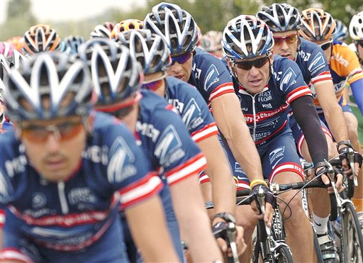 Then-U.S. Postal Service team leader and five-time Tour de France winner Lance Armstrong, third from right, rides in the second stage of the 91st Tour de France in this July 5, 2004, photo.