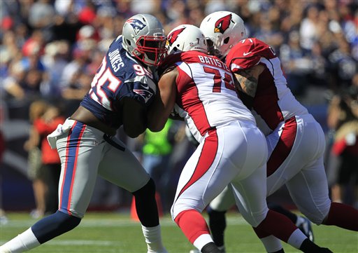 New England Patriots defensive end Chandler Jones, left, tries to get past the blocking by Arizona Cardinals tackle D'Anthony Batiste (74) and guard Daryn Colledge (71) in the first quarter of an NFL football game Sunday, Sept. 16, 2012 in Foxborough, Mass. (AP Photo/Steven Senne)