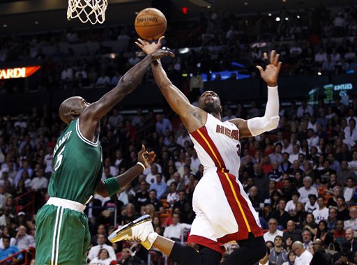 Boston Celtics' Kevin Garnett (5) tries to block a shot by Miami Heat's Dwyane Wade (3) during the first half of an NBA basketball game in Miami, Tuesday, Oct. 30, 2012. The Heat won 120-107. (AP Photo/J Pat Carter)