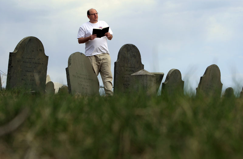 Walter Skold of Freeport reads a Henry Wadsworth Longfellow poem in Portland's Eastern Cemetery in this April 20, 2010, photo.