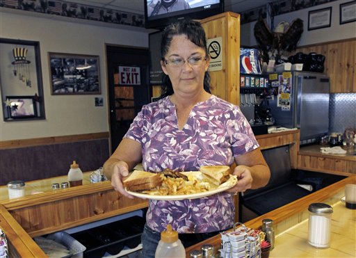 Millie Brown, a cook and waitress at Buch's truck stop, serves a breakfast, in Steubenville, Ohio., recently. U.S. service companies grew in September at the fastest pace since March.
