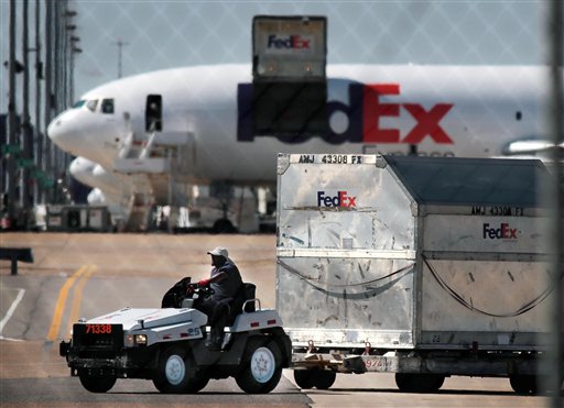 FedEx workers unload planes at the Memphis International hub earlier this month. FedEx expects to handle 280 million shipments between Thanksgiving and Christmas, up 13 percent from last year.