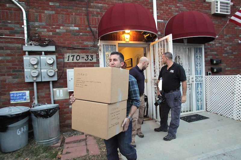 Law enforcement officials remove boxes of potential evidence from the New York home where Quazi Mohammad Rezwanul Ahsan Nafis was staying, Wednesday, Oct. 17, 2012. Nafis was arrested in an FBI sting operation earlier in the day after attempting to blow up a fake car bomb outside the Federal Reserve building in Manhattan, authorities said. (AP Photo/Newsday, Howard Schnapp)