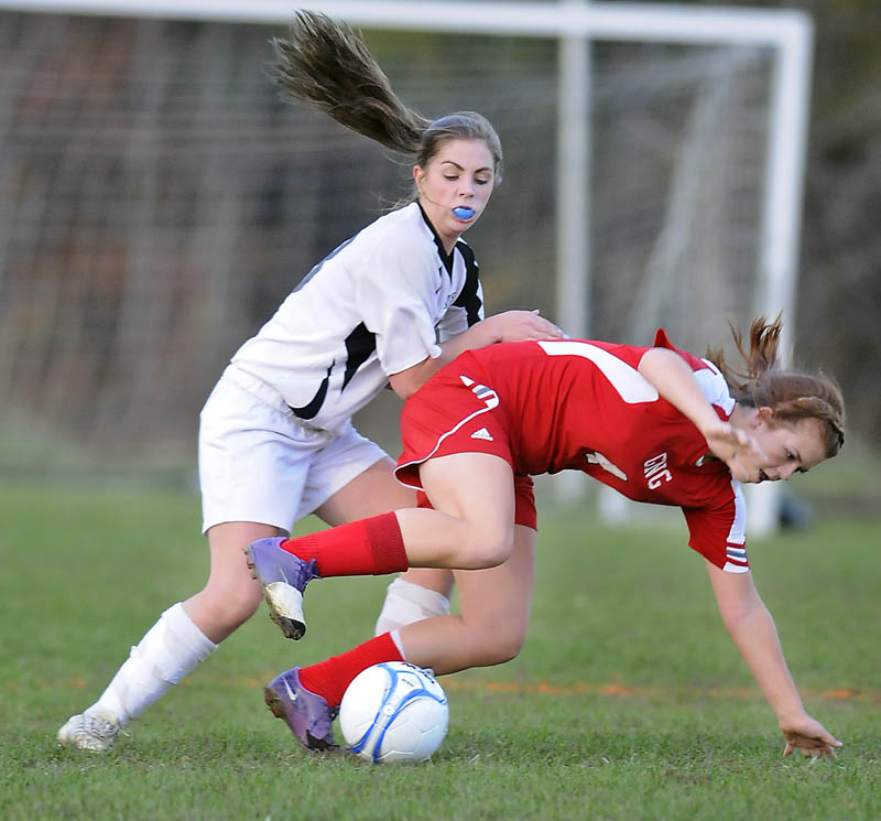 TOUGH DEFENSE: Maranacook Community School’s Sarah Clough, left, knocks Gray-New Glouces-ter’s Sarah Giggey away from the ball Tuesday during a Western Class B quarterfinal game in Readfield.