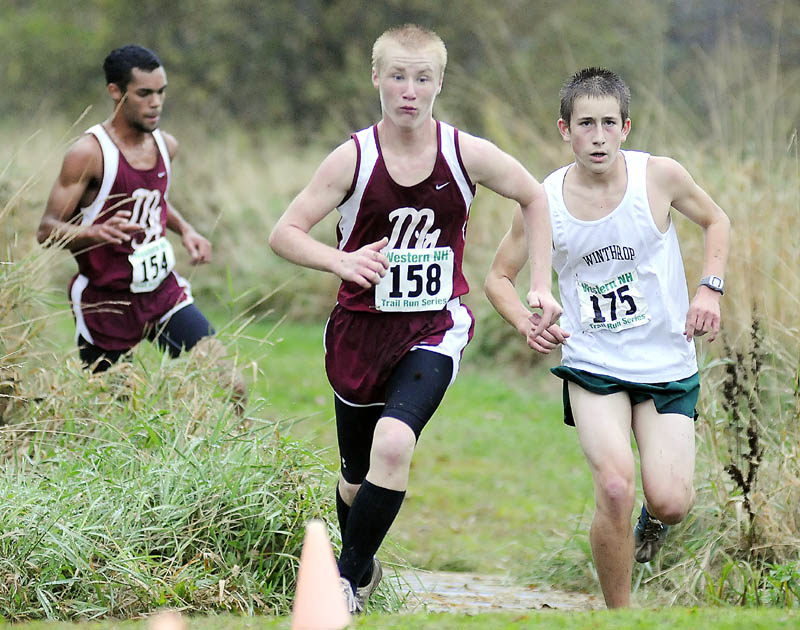 Monmouth Academy’s Alex Turbide, center, breaks ahead of of Winthrop High School’s Mathias Deming, right, as Monmouth’s Marcques Houston closes in Wednesday during a cross country meet at Monmouth Academy.