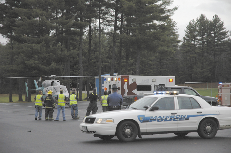 A LifeFlight of Maine helicopter arrives Wednesday afternoon at a Madison High School parking lot to airlift Kerry Hebert, of Starks, to Central Maine Medical Center in Lewiston. Herbert was shot Wednesday in a possible "hunting-related incident," according to police.