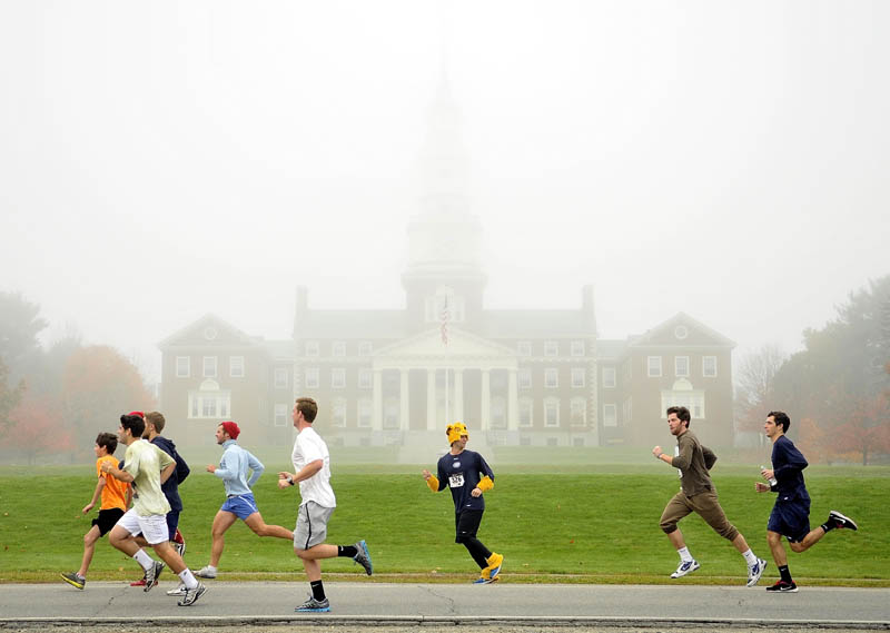 Participants in the 4th annual Freaky 5k Run and Walk hosted by Hardy Girls Healthy Women Colby Volunteer Center run down Mayflower Hill Drive in front of the Miller Library at Colby College Saturday morning.