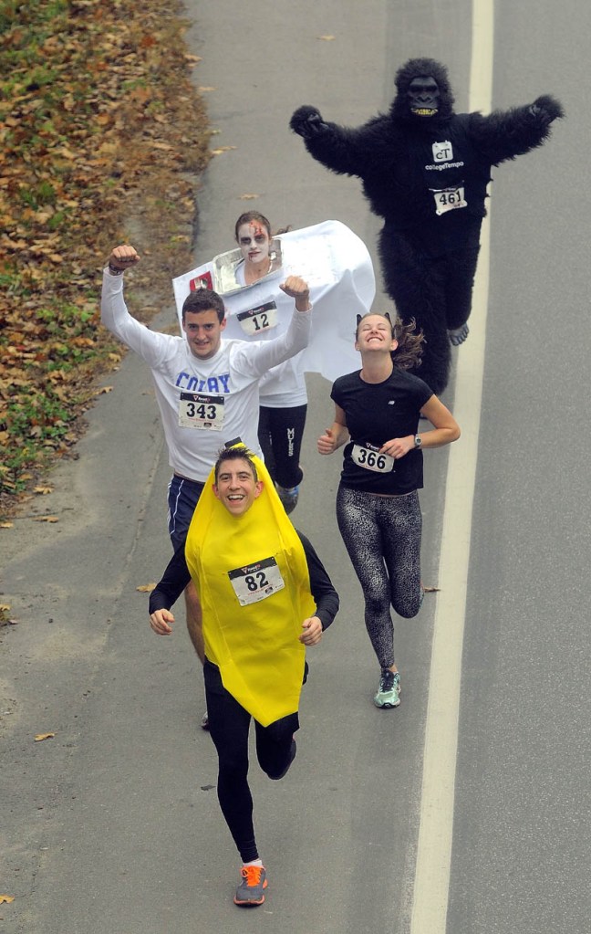 Participants in the 4th annual Freaky 5k Run and Walk hosted by Hardy Girls Healthy Women Colby Volunteer Center run up Mayflower Hill Drive near Colby College Saturday.