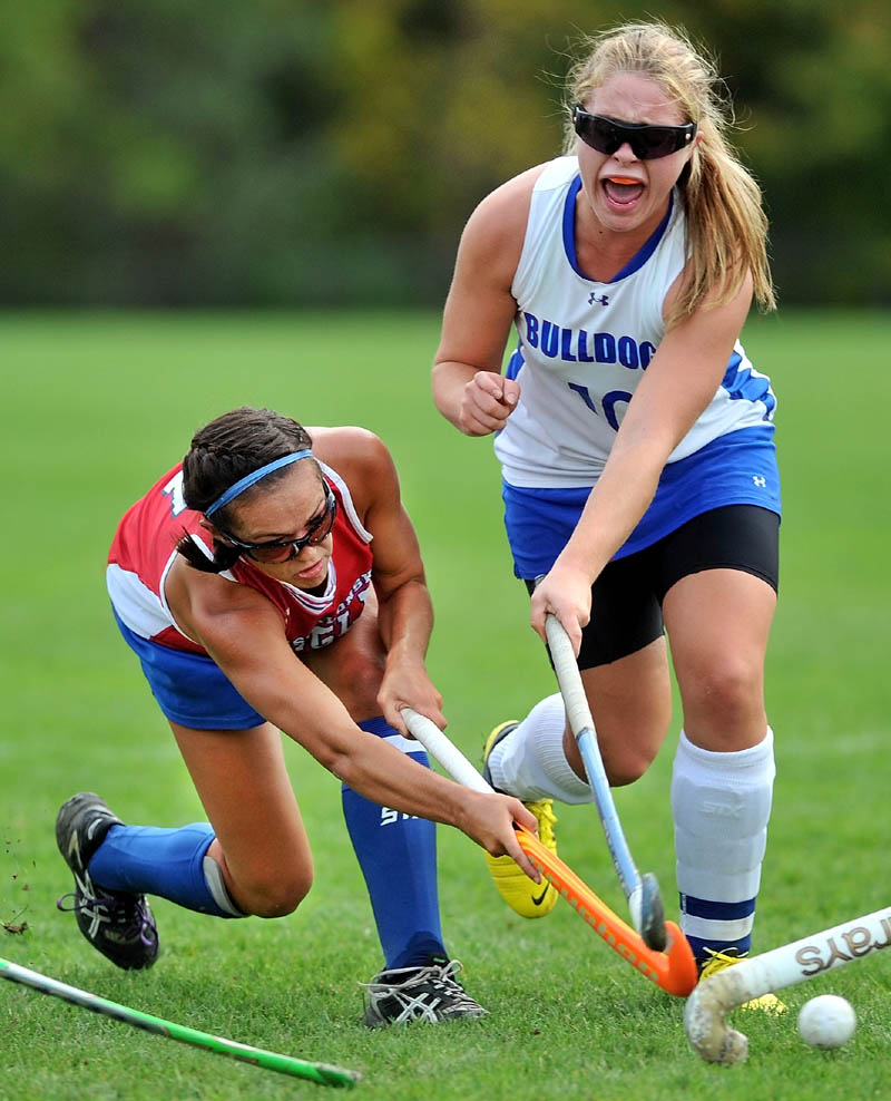 Take the shot: Messalonskee’s Kristy Bernatchez, left, takes a shot on goal as Lawrence’s Sasha Letourneau defends it in the first half in Fairfield Tuesday. Messalonskee defeated Lawrence 7-0.