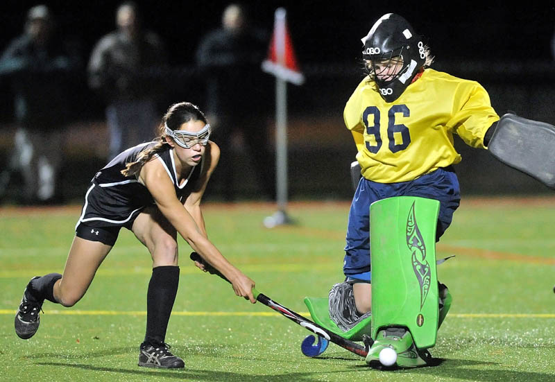 KICK SAVE: Skowhegan’s Brooke Michonski, left, takes a shot on Belfast goalie Julia Ward, right, during a Kennebec Valley Athletic Conference championship game Thursday at Thomas College.