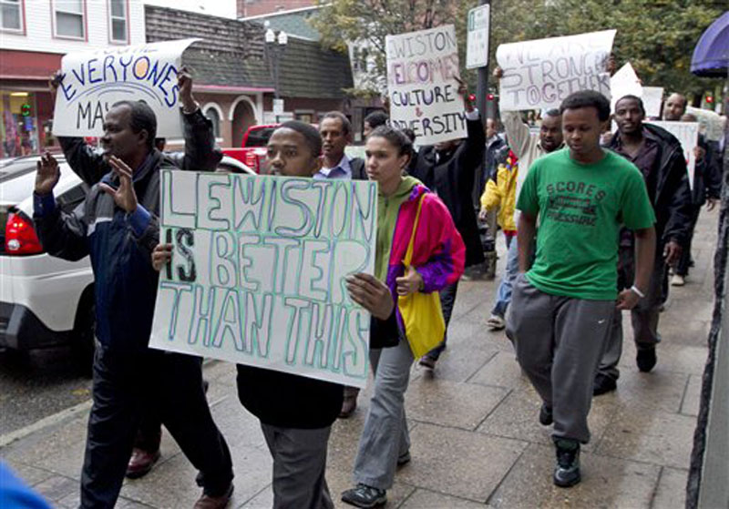 Protesters march in Lewiston, Maine, after delivering petitions asking for the resignation of the city's mayor because of comments he made about Somali refugees,Thursday, Oct. 4, 2012. (AP Photo/Robert F. Bukaty)
