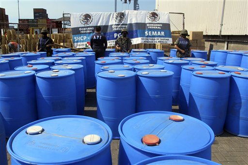 In this file photo released by the Mexican navy, Navy marines stand guard over barrels containing 120,000 kilograms of methylamine, a precursor chemical, seized at the Pacific port of Lazaro Cardenas, Mexico, that were headed for Guatemala. The meth problem is spilling into other parts of Latin America, too, almost all of it bound for Guatemala.