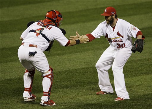 St. Louis Cardinals relief pitcher Jason Motte (30) and St. Louis Cardinals catcher Yadier Molina (4) celebrate after the Cardinals beat the San Francisco Giants 3-1 in Game 3 of baseball's National League championship series Wednesday, Oct. 17, 2012, in St. Louis. (AP Photo/Patrick Semansky)