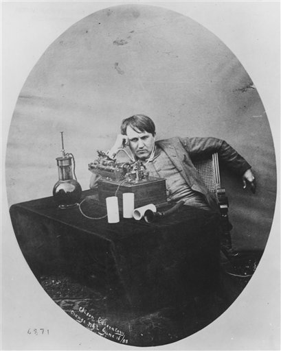 A 1888 photo of Thomas Edison listening to a wax cylinder phonograph.