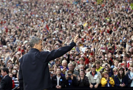 President Barack Obama waves to supporters as he takes the stage during a campaign event at the University of Wisconsin-Madison on Thursday.