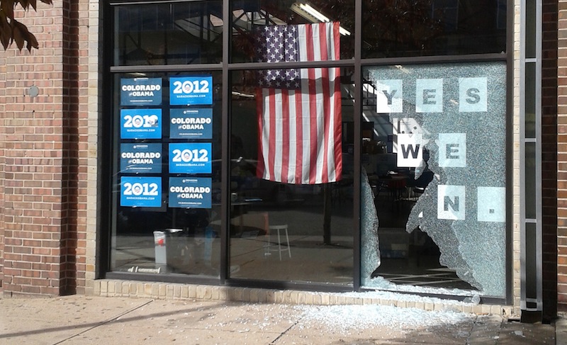 This photo provided by Courtney Grimm shows the shattered glass outside of President Barack Obama's Denver campaign office on Friday, Oct. 12, 2012. Denver police say someone gired a shot through the window of the campaign office while people were inside the office. On Friday, Oct. 19, 2012, someone also spray-painted swastikas on President Barack Obama's campaign office in Conifer, Colo. (AP Photo/Courtney Grimm)