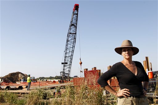Julia Trigg Crawford stands on a road in front of a neighboring property to her family farm where work by TransCanada continues on an oil pipeline recently in Sumner, Texas.